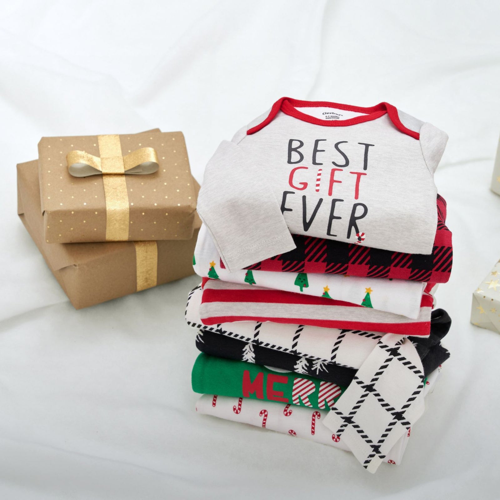 A stack of beautifully wrapped Christmas presents adorned with the words "Best Gift Ever" in festive typography.