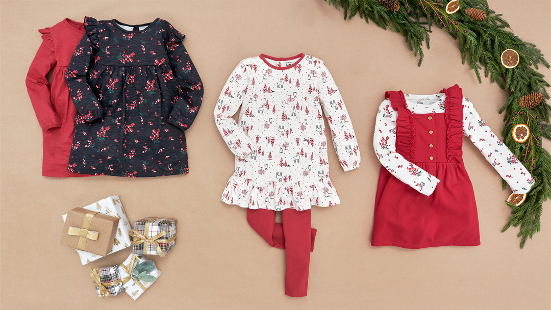 Festive attire for toddlers and babies: a red dress, a red sweater, and a red bow; the perfect Christmas outfits for little ones.